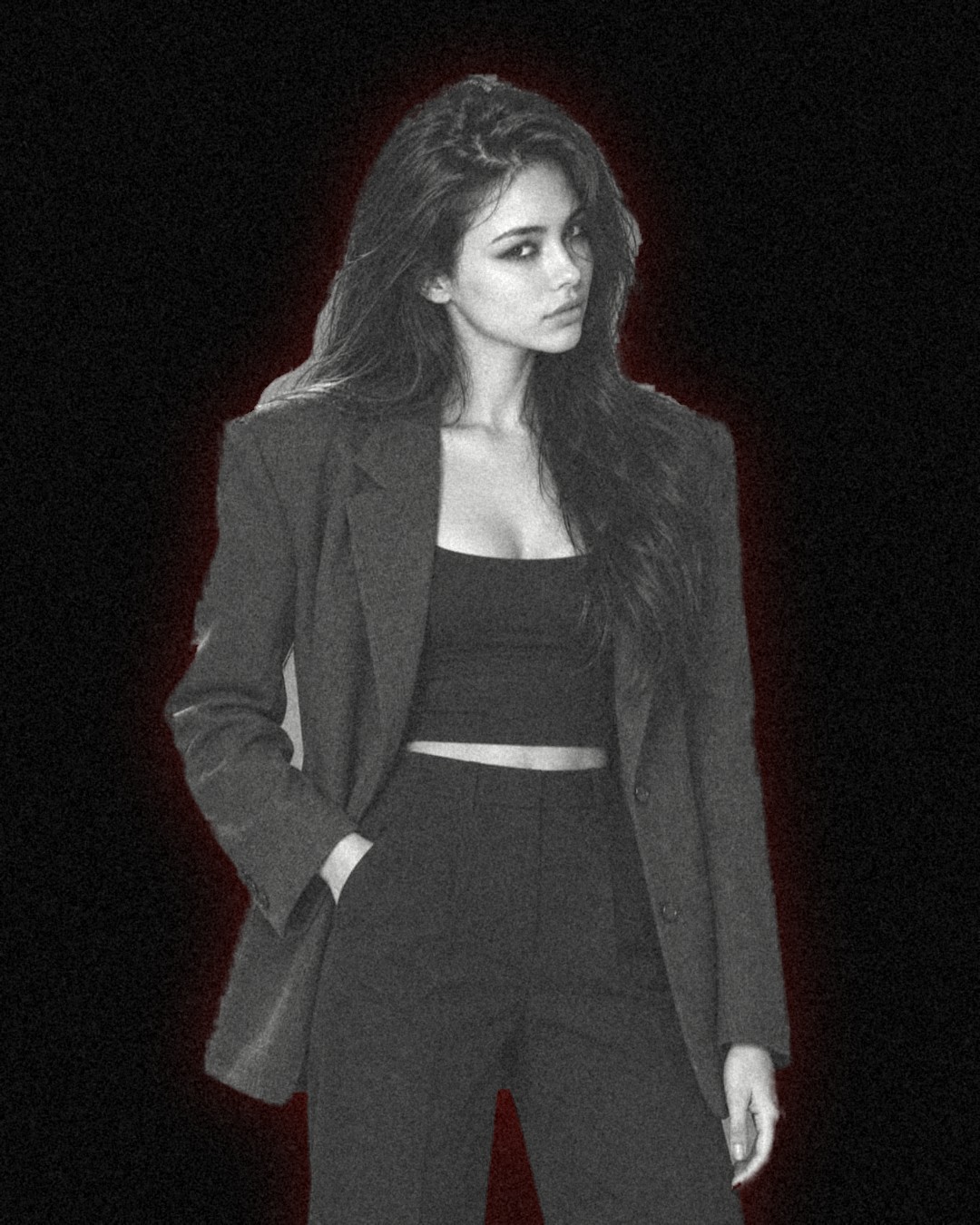 Pat Villaceran, waist up on an ink background. Long dark hair, a charcoal blazer, and a black top.